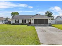 Charming single-story home with a well-maintained lawn and inviting curb appeal on a sunny day at 2966 Derby Dr, Deltona, FL 32738