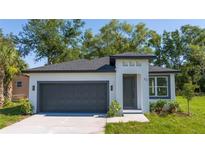 Charming single-Gathering home featuring a two-car garage, well-maintained landscaping, and modern architectural details at 33 W 7Th St, Apopka, FL 32703