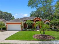 Charming one-story home with a beautiful front lawn, palm trees, and an attached two-car garage at 3518 Edlingham Ct, Belle Isle, FL 32812