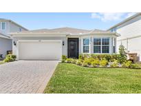 Beautiful home with manicured lawn, brick paved driveway and attached two car garage at 5641 Oak Knoll Dr, St Cloud, FL 34771