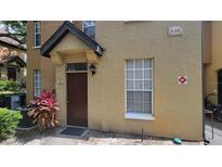 Inviting townhouse featuring a well-maintained exterior and a private entrance at 6316 Raleigh St # 401, Orlando, FL 32835