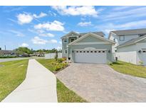 Charming two-story home with a paved driveway and attached two-car garage at 701 Dennis Ave, Orlando, FL 32807