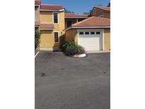 Charming townhome exterior with a single-car garage and well-maintained landscaping at 706 Lighthouse Ct, Altamonte Springs, FL 32714