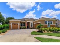 Charming one-story home features a beautifully paved driveway, well-manicured landscaping, and a welcoming entryway at 14830 Winkfield Ct, Winter Garden, FL 34787