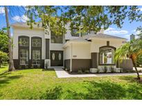 Inviting two-story home featuring manicured lawn and a charming front entrance at 14927 Faversham Cir, Orlando, FL 32826