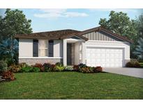 Charming one-story home featuring a two-car garage, stone accents, lush landscaping, and welcoming front entrance at 2089 Rosewood Dr, Bartow, FL 33830