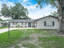 Charming single-story home features fresh exterior paint, a well-manicured lawn, and mature landscaping at 228 Kilmer Ln, Winter Haven, FL 33884