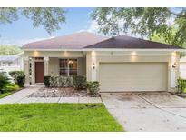 Charming single-story home with a well-manicured lawn and an attached two-car garage at 2280 Yorville Ct, Ocoee, FL 34761
