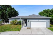 Charming single-story home with a well-manicured lawn and a two-car garage at 344 Buenaventura Blvd, Kissimmee, FL 34743
