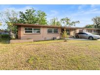 Charming single-story home with a well-maintained lawn and a classic neutral-toned exterior at 4546 Malibu St, Orlando, FL 32811