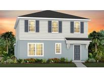 Charming two-story home featuring a light blue and white color scheme and well-maintained landscaping at 7420 Ivy Tendril Ave, Orlando, FL 32829