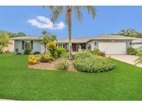 Charming home featuring a lush lawn, mature landscaping and a symmetrical exterior at 8134 Hook Cir, Orlando, FL 32836