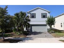 Charming two-story home with a well-maintained lawn and lush landscaping at 8930 Zurich Ln, Kissimmee, FL 34747