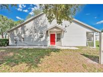 Charming home featuring a red front door and screened-in porch at 9616 River Walk Ct, Orlando, FL 32825