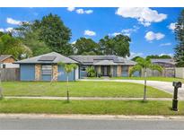 Charming single-story home featuring a well-manicured lawn and complementary exterior elements at 969 Gran Paseo Dr, Orlando, FL 32825