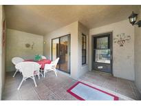 Charming covered patio with tile flooring, a dining table, and access to the unit's entrance at 1074 Kensington Park Ct # 101, Altamonte Springs, FL 32714