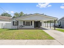 Charming single-story home featuring a covered porch, well-maintained lawn, and inviting curb appeal at 1623 Cumbie Ave, Orlando, FL 32804