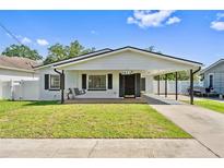 Charming single-story home with a well-maintained lawn and a convenient carport at 1623 Cumbie Ave, Orlando, FL 32804