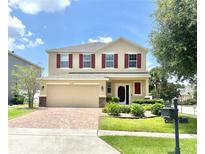 Charming two-story home with a brick-paved driveway, well-manicured lawn and front garden at 16334 Saint Augustine St, Clermont, FL 34714