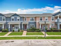 Charming townhomes with well-maintained lawns and colorful facades create a welcoming curb appeal at 16724 Cedar Crest Dr, Orlando, FL 32828