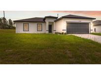 Charming one-story home featuring a two-car garage, landscaped yard, and modern architectural details at 17139 Sw 44Th Cir, Ocala, FL 34473