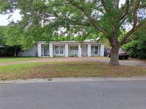 Charming single-story home featuring dual entryways, brick driveway, and mature tree providing ample shade at 1773 Walnut Ave, Winter Park, FL 32789