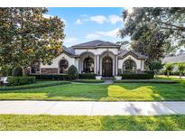 Charming one-story home with arched entryways, manicured landscaping, and a well-maintained lawn at 190 Osprey Hammock Trl, Sanford, FL 32771