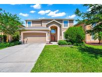 Charming two-story home with a well-manicured lawn and inviting curb appeal on a beautiful day at 2209 Crofton Ave, Davenport, FL 33837