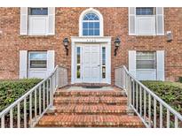 A beautiful brick house with a white front door, flanked by white-framed windows, and a lovely brick stairway entrance at 4306 Lake Underhill Rd # C, Orlando, FL 32803