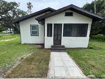 Charming single-story home features a screened porch and newly landscaped walkway to the front door at 506 South St, Daytona Beach, FL 32114
