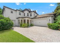 Elegant two-story home featuring a stone-accented entrance, three-car garage and meticulously paved driveway at 808 Sherbourne Cir, Lake Mary, FL 32746