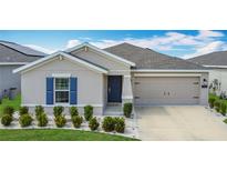 Charming single-story home with a well-manicured lawn and two-car garage in a sunny, vibrant neighborhood at 1120 Saguaro St, Haines City, FL 33844