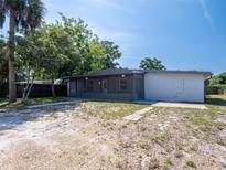 Charming home featuring a screened in porch and a well-maintained gravel yard at 1229 Deneece Ter, Daytona Beach, FL 32117