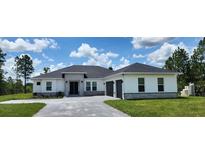 Beautiful single-story home with stone accents, gray roof and manicured lawn on a sunny day at 160 Steeplechase Cir, Sanford, FL 32771