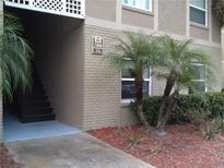 Condo building exterior with lush landscaping and visible unit number marker at 2408 Swailes Dr # 6, Orlando, FL 32837