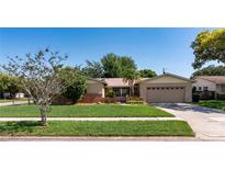 Charming single-story home with well-manicured lawn and mature landscaping at 3121 Thistlehill Drive, Winter Park, FL 32792