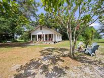 Charming one-story home with a cozy front porch, fire pit, and a spacious, tree-shaded yard at 485 Palm St, Winter Garden, FL 34787