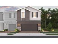 Modern two-story home with a gray color scheme, a two-car garage, and manicured landscaping at 564 Southern Edge Way, Sanford, FL 32771