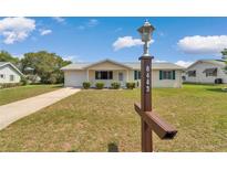 Charming single-story home with a well-maintained lawn and inviting front porch at 8443 Sw 109Th Pl, Ocala, FL 34481