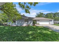 Charming single-Gathering home featuring a well-maintained lawn and mature trees at 107 Thrush Ln, Casselberry, FL 32707