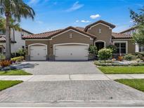 Charming single-Gathering home with a tile roof, three-car garage, and beautiful landscaping at 11741 Savona Way, Orlando, FL 32827