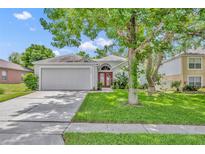 Charming single-story home featuring a well-manicured lawn and a two-car garage in a quiet neighborhood at 1181 Welch Hill Cir, Apopka, FL 32712
