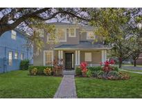 Charming two-story home with a well-manicured lawn and inviting front porch at 14835 Old Thicket Trce, Winter Garden, FL 34787