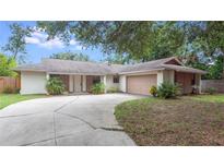 Charming single-story home with a two-car garage and well-maintained front yard at 1525 Jaguar Cir, Apopka, FL 32712