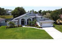 Beautiful single-story home boasts a manicured lawn and well-maintained landscaping at 1676 Bear Crossing Cir, Apopka, FL 32703