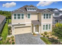 Charming two-story home featuring a two-car garage, neat landscaping, and a welcoming front porch at 200 Azure Mist Way, Daytona Beach, FL 32124