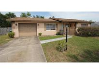 Charming single-Gathering home featuring a driveway, a well-kept lawn, and a cozy front porch at 2013 Dearing Ave, Deltona, FL 32725
