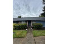 Charming single-story home featuring a brick facade, well-manicured landscaping, and inviting entryway walkway at 2750 King Oak Cir, St Cloud, FL 34769
