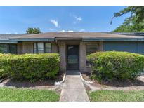 Charming single-story home features brick accents, mature landscaping, and a welcoming entrance at 2750 King Oak Cir, St Cloud, FL 34769