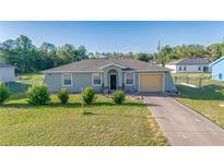 Charming single-story home with a well-maintained lawn, cozy front porch, and attached garage at 2801 Sw 139Th St, Ocala, FL 34473